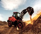 Doosan DL280-5 Wheel Loader dumping dirty on a desert jobsite.